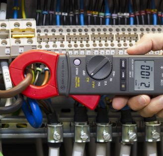 41845711 - electrician measuring current with current clamp.